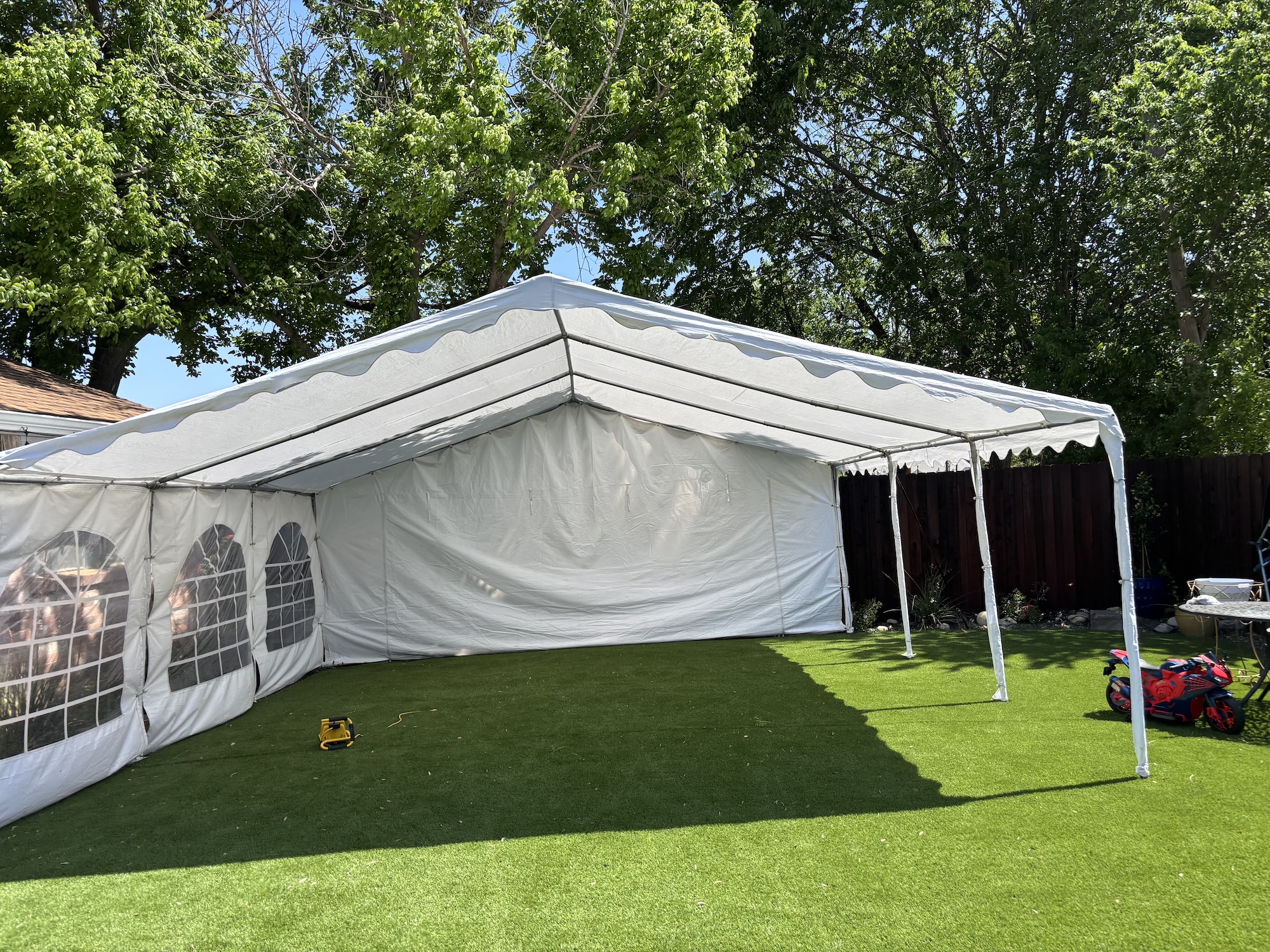 Frame tent rental setup in Dallas County backyard